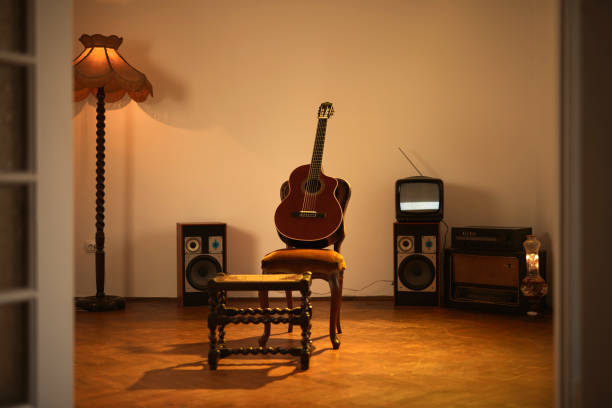 istock Acoustic guitar in a retro vintage room. 1321336557