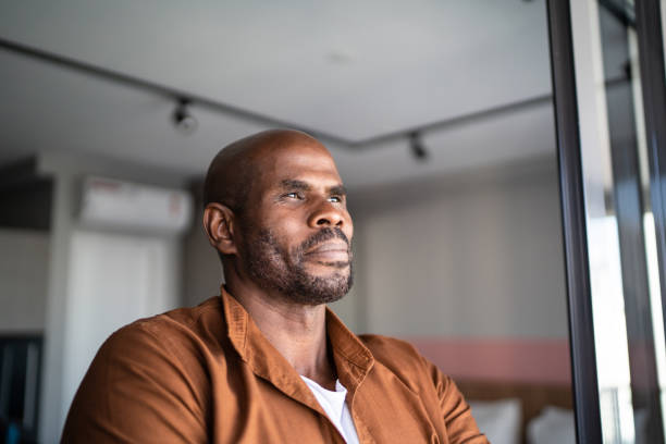 istock Mature man contemplating at home 1321336559