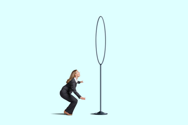 istock Woman Attempting To Jump Through Hoops 1321336640