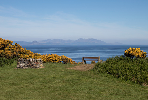View of Isle of Arran in Scotland with barbecue pit and park bench