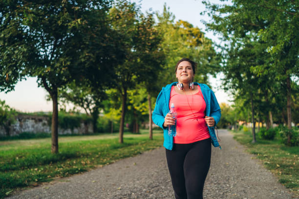 istock Young overweight woman running 1321339364