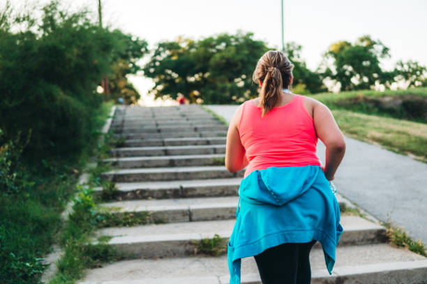 istock Young overweight woman running 1321339381
