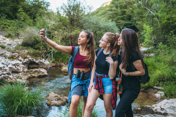 istock Young women making hiking break for selfie in nature 1321340237