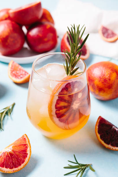 istock Delicious Blood Orange Cocktail on light blue background. Summer cocktails, refreshing drinks, low alcohol mocktail concept. 1321342000