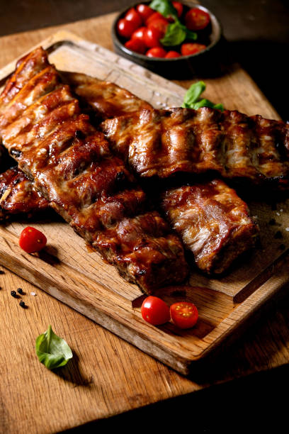 istock Grilled pork bbq ribs served with cherry tomatoes 1321342952