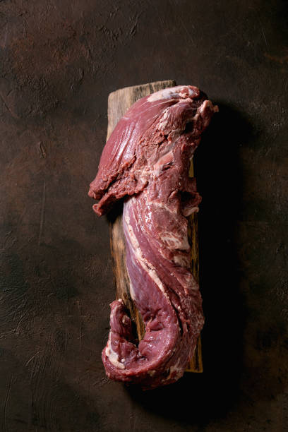 istock Fresh whole raw beef tenderloin on wooden board 1321342986