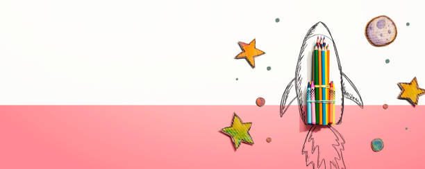 istock Back to school theme with a rocket and colored pencils 1321343106