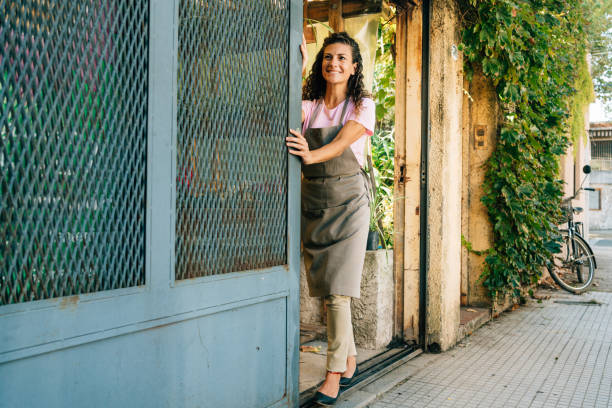 Owner opening store in the morning Plant nursery owner sliding the store doors open in the morning opening event stock pictures, royalty-free photos & images