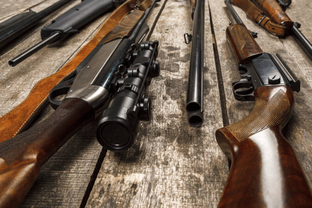 istock Many hunting rifles on weathered wooden surface 1321347659