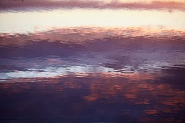 istock Water surface with abstract pattern and colorful reflections close-up 1321349640