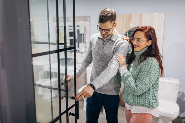 Young couple making decision which shower will set perfectly in their new home