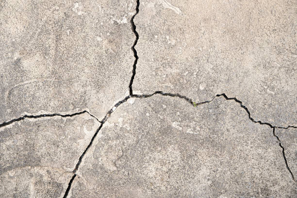 istock Concrete background with cracks. Gray cracked concrete 1321351511
