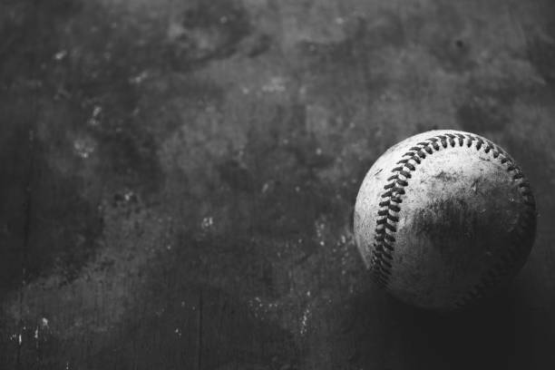 istock baseball ball and a black grunge background 1321353172