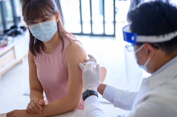 istock The doctor prepares the syringe for vaccination 1321354723