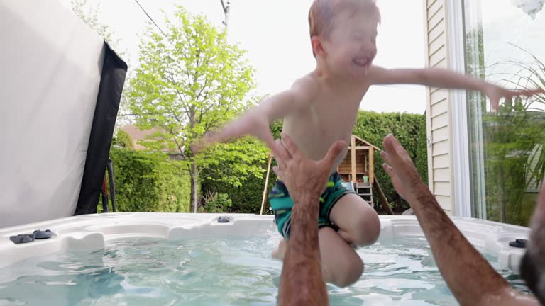 Cute Redhead Kid and Father in the Hot Tub in the Backyard in Summer