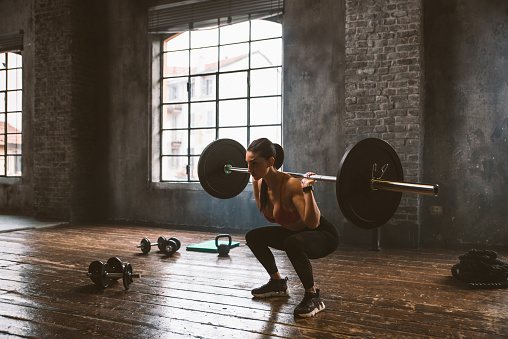 Beautiful woman training and making functional workout in the gym