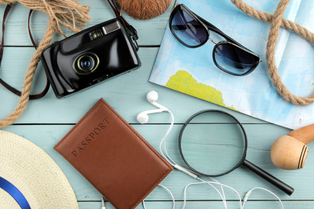 istock Travel concept Glasses, camera, passport, map and shells on a blue wooden table. relaxation. holidays. top view 1321357719