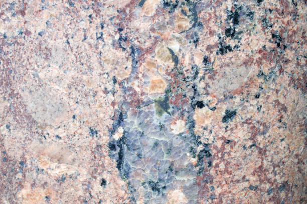 istock A cracked gray granite stone with pink veins. Marble surface. Beautiful patterns and lines. 1321358405