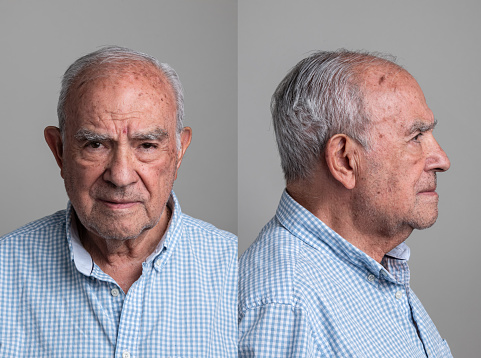 Serious hispanic senior man front and profile mugshots on gray background