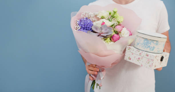 istock Delivery man with bouquet flowers 1321358686