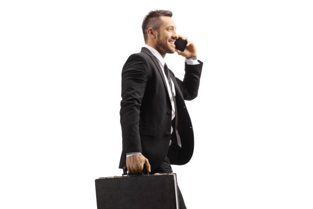 istock Young businessman walking and talking on a mobile phone 1321359599