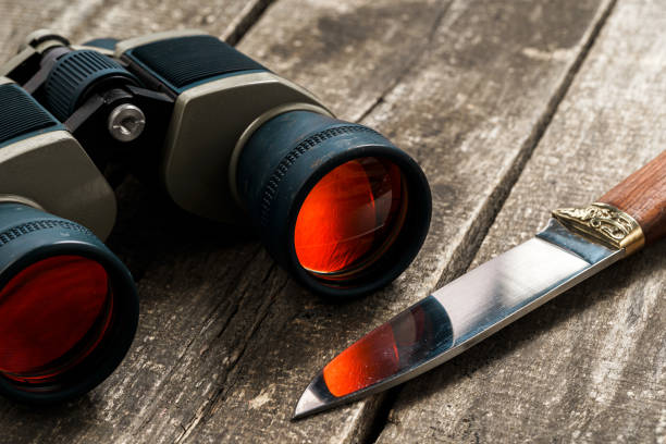 istock Hunting equipment binoculars on wooden background close up 1321359606