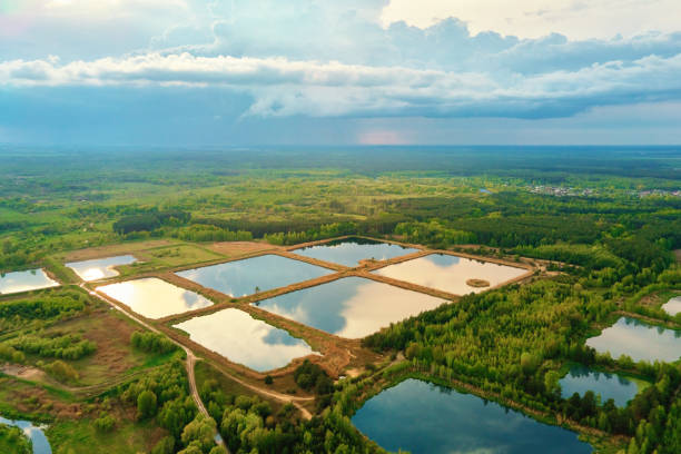 stormwater ponds or rainwater artifical basins, aerial view - sewage pond imagens e fotografias de stock