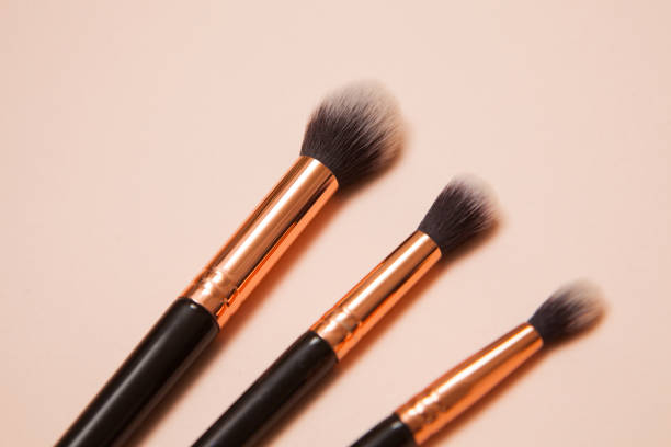 istock Various cosmetic brushes on pink background. Makeup brushes set for take care skin. 1321359796