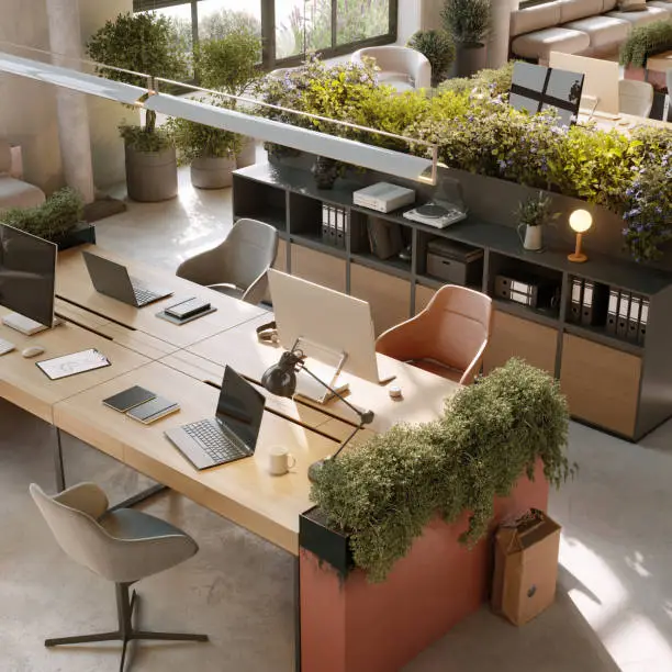 3D image of a environmentally friendly office space. High angle view of a modern office desks with plants.