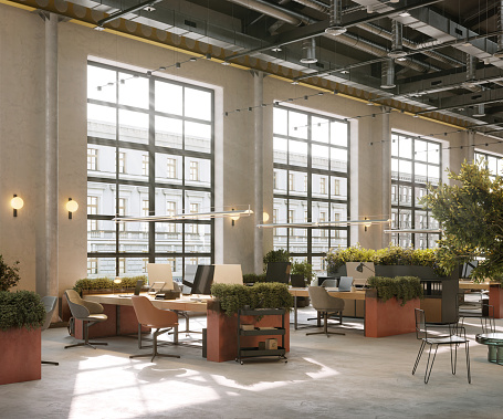 3D Rendering of a large open plan office with plants. Coworking work place in a creative office with large window.