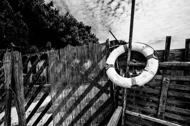 vintage round lifebuoy abandoned on the gate of a house at the Laguna dello Stagnone Marsala Trapani Sicily Italy