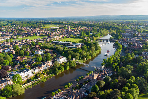 Aerial view of River Dee in Chester at dusk including Queens Park Bridge and The Old Dee Bridge, Cheshire, England, UK