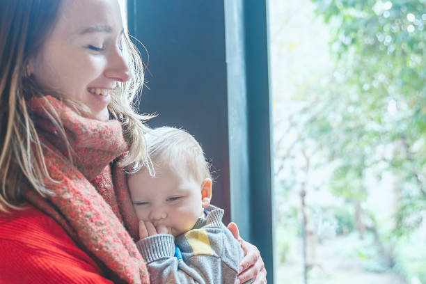 istock Baby sleeping on mother's lap 1321365817