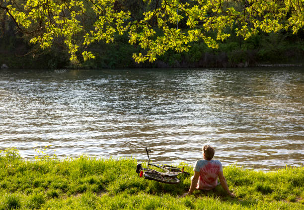 Man enjoying the park views stock photo. Photographing river.
