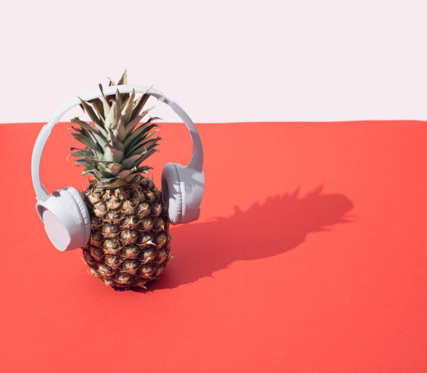 istock Summer creative minimal arrangement with pineapple and headphones. 1321367120