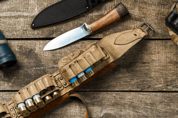 istock Various hunting equipment on old wooden background 1321367137