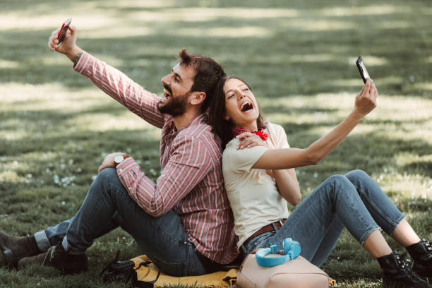 istock Young Smiling Couple Making A Self Portrait With Phone. 1321367546
