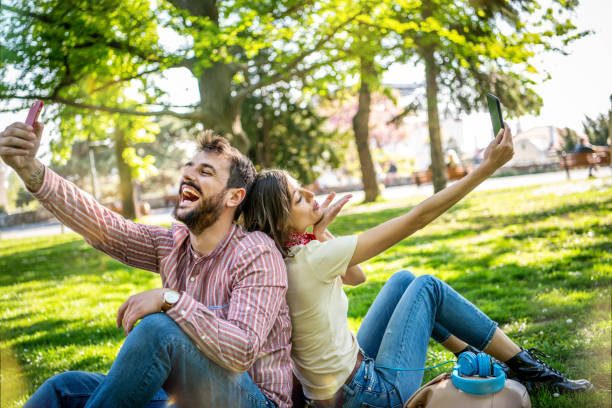 istock Young Smiling Couple Making A Self Portrait 1321367572