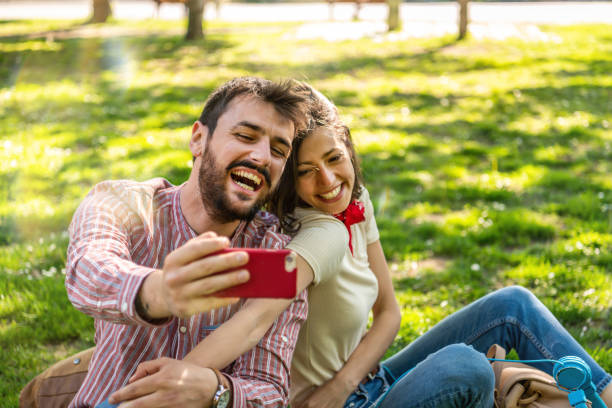 istock Young Smiling Couple Making A Self Portrait 1321367604