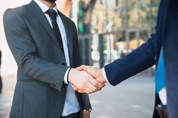 istock Handshake of two young businessmen 1321367714