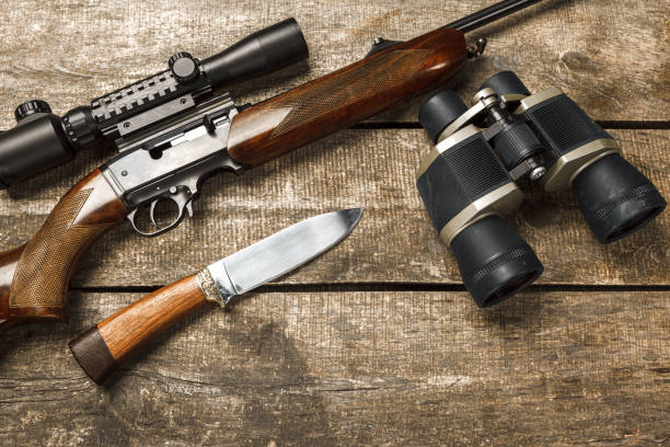 istock Hunting rifle and binoculars on dark wooden background 1321368406