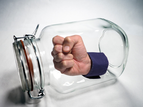 Fist isolated into a jar