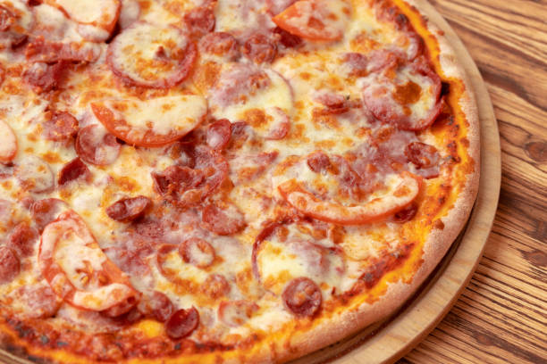 istock Freshly baked pizza on table close up 1321370151