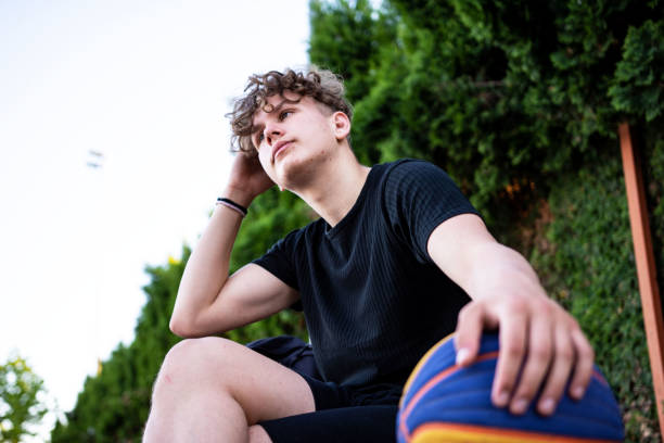 istock Young basketball player sitting on the bench 1321371061
