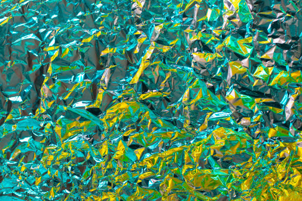 Chrome tint foil  texture with crumpled structure effect. Fashion luxury background with brave vibrant modern colors of Biscay green, turquoise and yellow lime