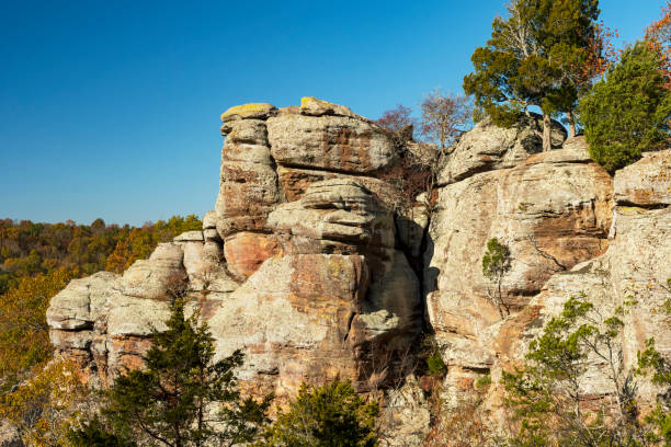 Eroded and Colorful Sandstone Bluffs on a Sunny Day Eroded and Colorful Sandstone Bluffs on a Sunny Day in the Garden of the Gods Near Herod, Illinois outcrop stock pictures, royalty-free photos & images