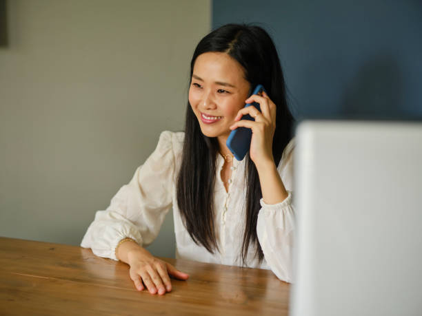 istock Asian Woman Talking on a Phone 1321372613