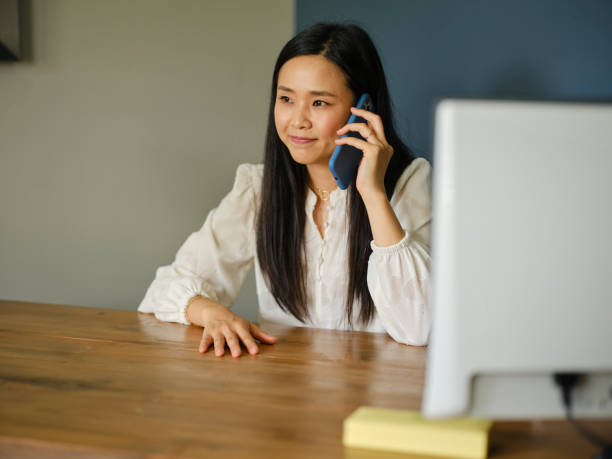 istock Asian Woman Talking on a Phone 1321372639