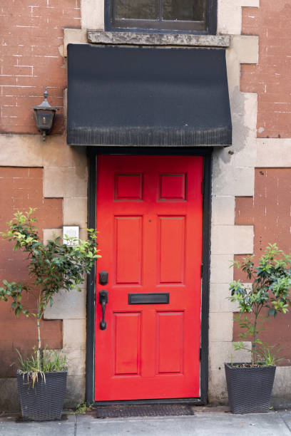 istock Bright red exterior front door with black awning 1321372645