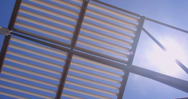 istock Metal construction against backdrop sun Protection from wind rain walls building 1321372869